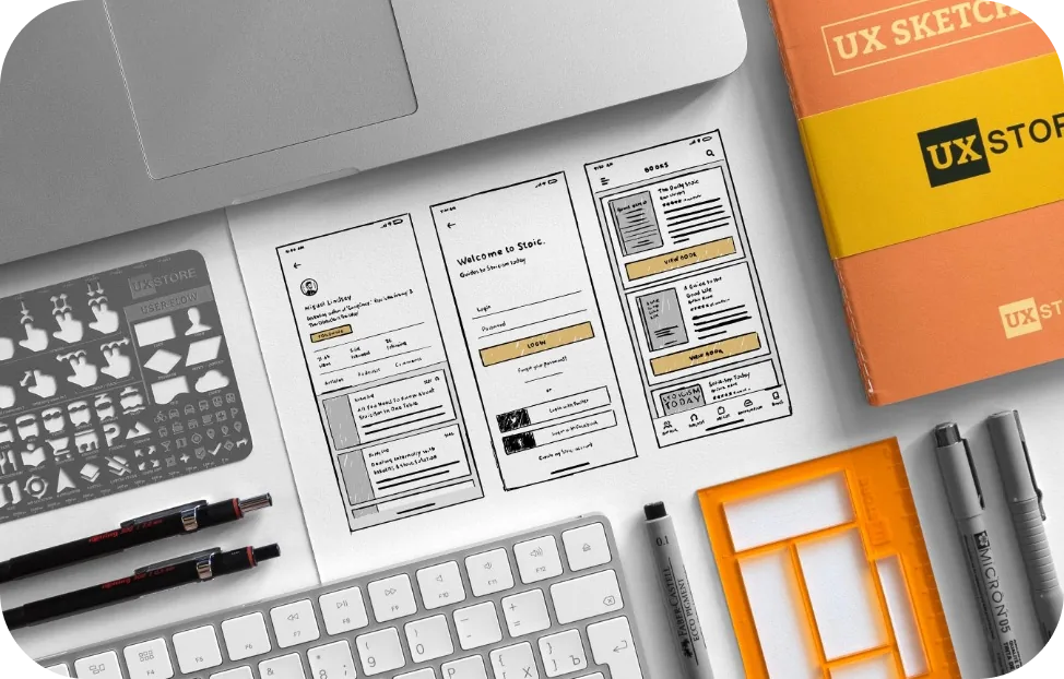 UX sketches, wireframes and design tools laid out on a desk